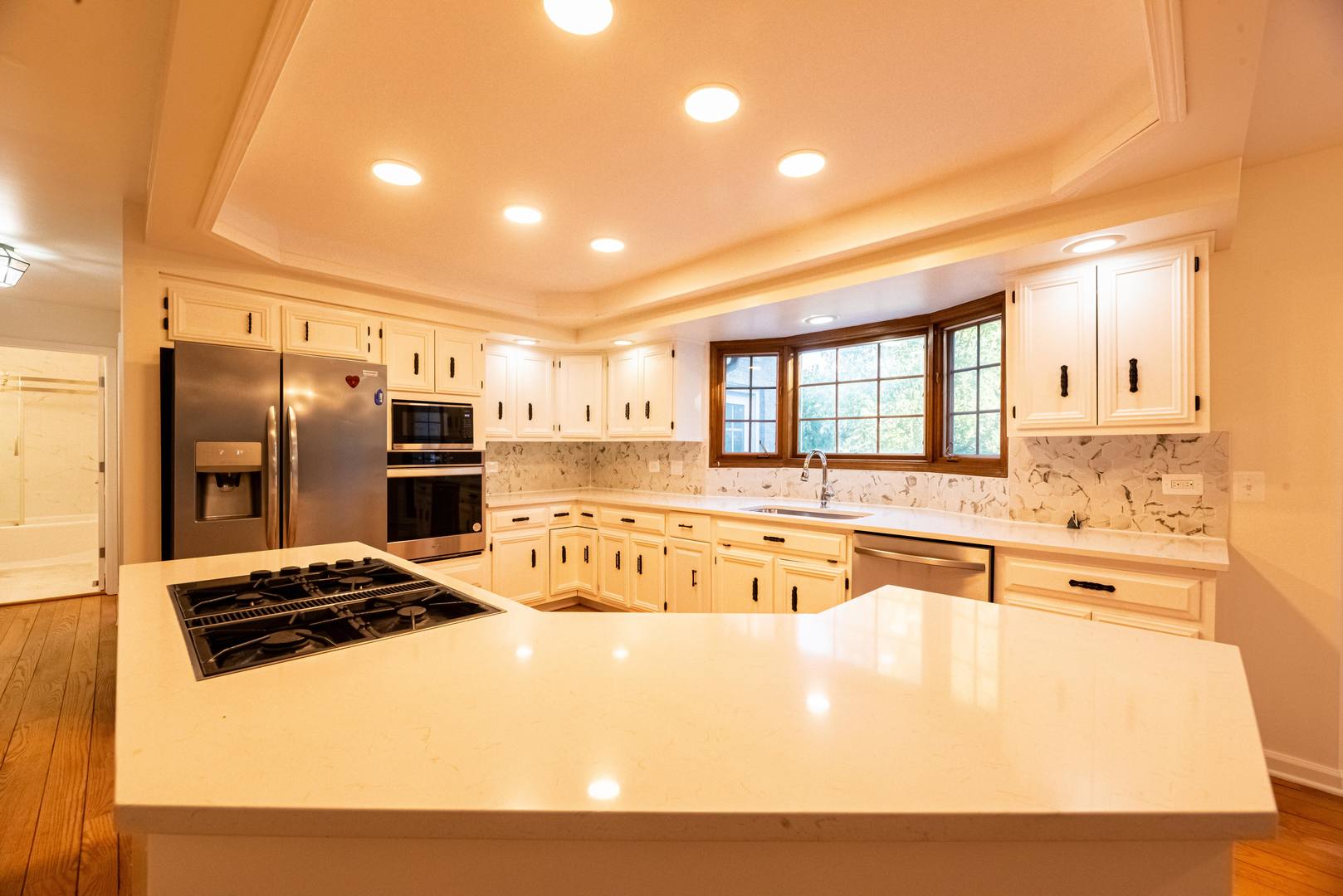3021 35th Street Oak Brook, IL 60523 - Photo 9 of 32 a large kitchen with stainless steel appliances a refrigerator and a stove