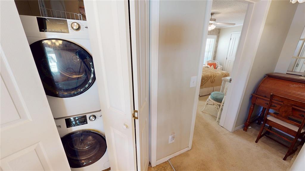 10101 Burnt Store Road, Unit 141 Punta Gorda, FL 33950 - Photo 13 of 34 a view of a bedroom with washer and dryer