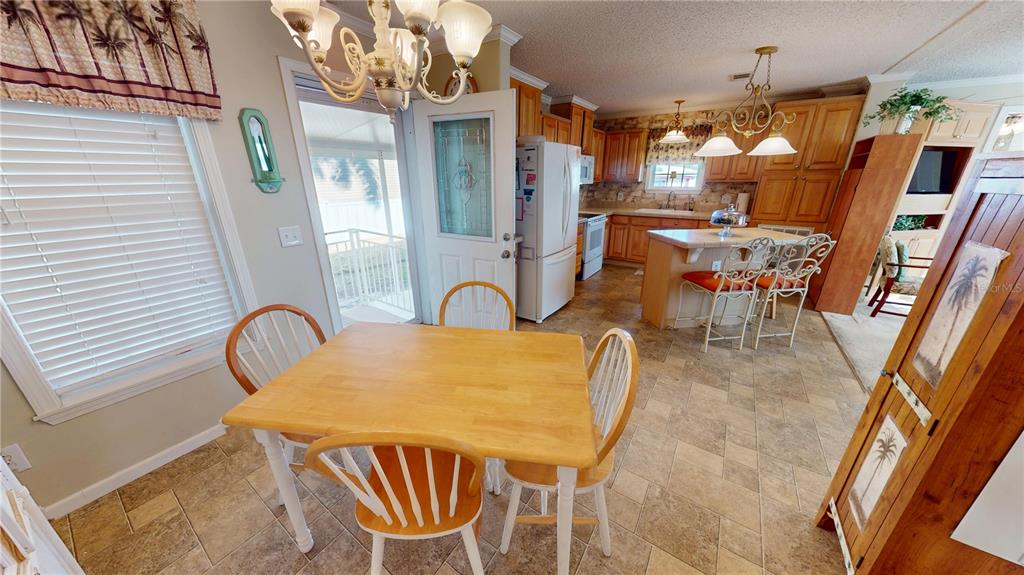 10101 Burnt Store Road, Unit 141 Punta Gorda, FL 33950 - Photo 20 of 34 a view of a dining room with furniture and chandelier