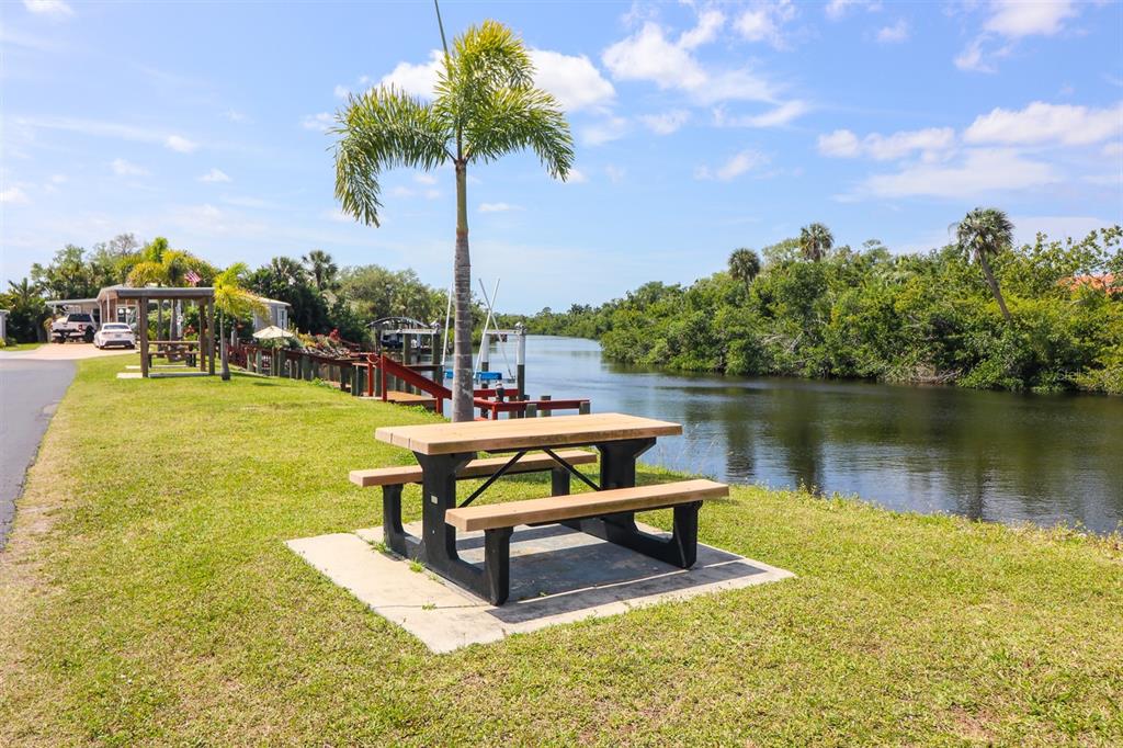 10101 Burnt Store Road, Unit 141 Punta Gorda, FL 33950 - Photo 30 of 34 a view of a lake with couches chairs