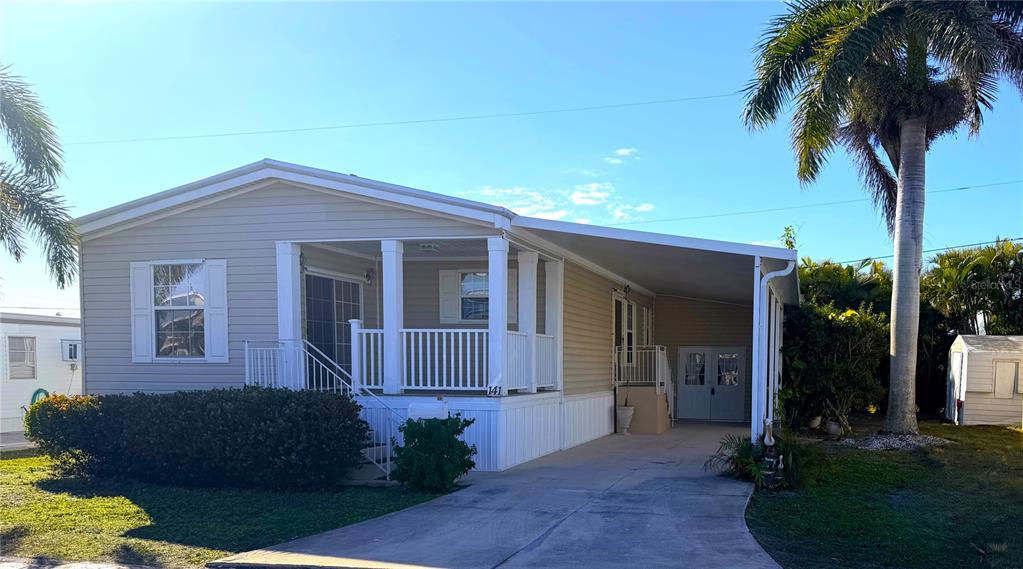 10101 Burnt Store Road, Unit 141 Punta Gorda, FL 33950 - Photo 3 of 34 a front view of a house with a garden