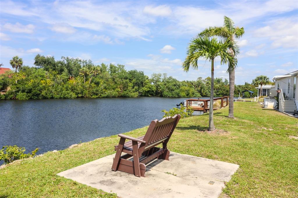 10101 Burnt Store Road, Unit 141 Punta Gorda, FL 33950 - Photo 31 of 34 a swimming pool with lounge chair in front of house