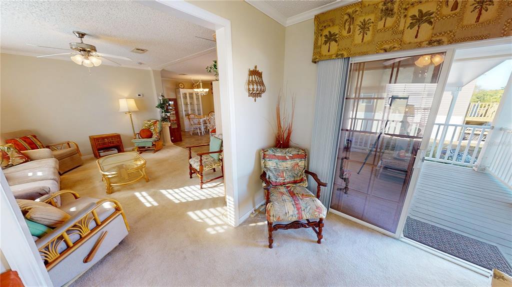 10101 Burnt Store Road, Unit 141 Punta Gorda, FL 33950 - Photo 5 of 34 a living room with furniture and wooden floor