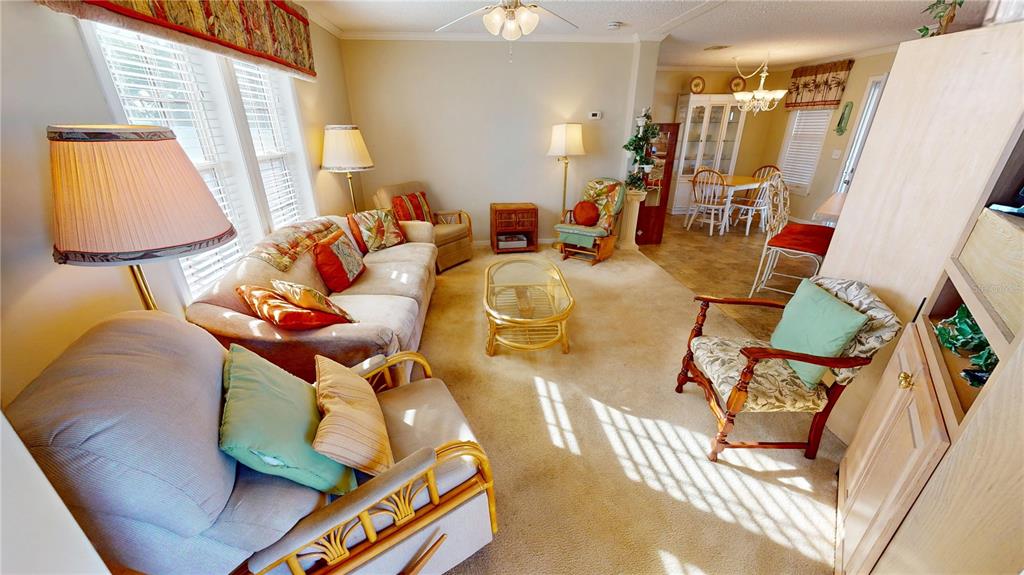 10101 Burnt Store Road, Unit 141 Punta Gorda, FL 33950 - Photo 6 of 34 a living room with furniture and a window