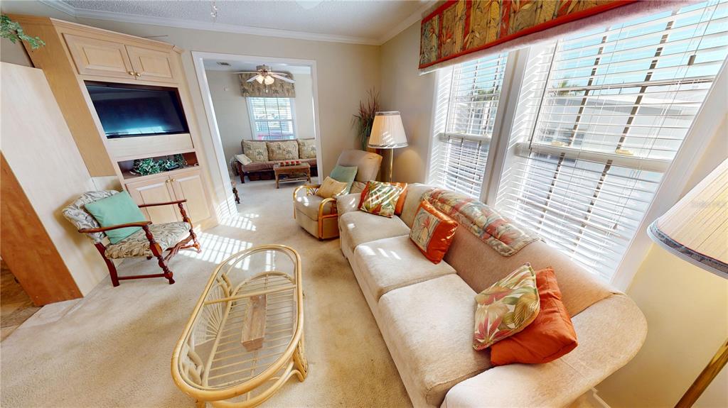 10101 Burnt Store Road, Unit 141 Punta Gorda, FL 33950 - Photo 7 of 34 a living room with furniture and a fireplace