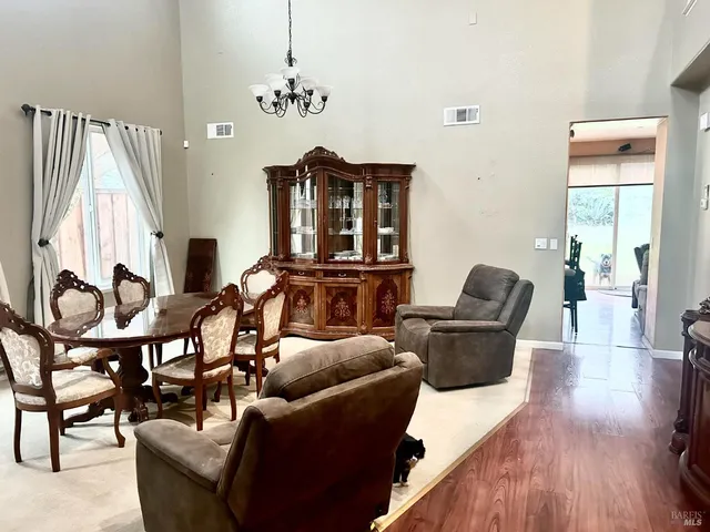 a living room with furniture a rug and a window