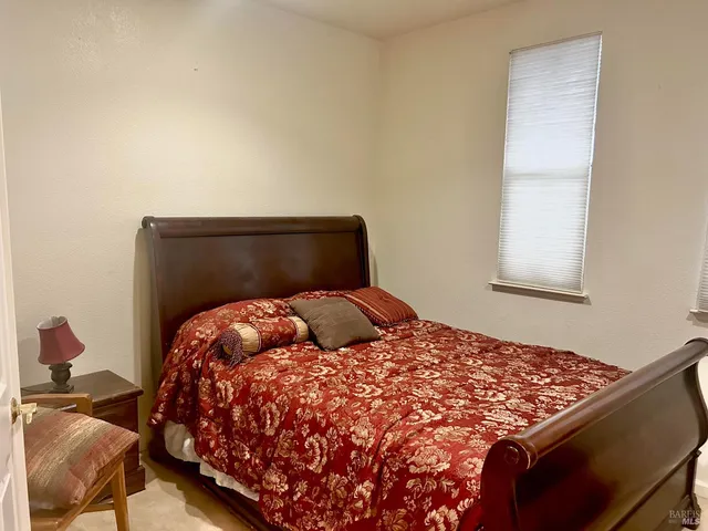 a bedroom with a bed and window