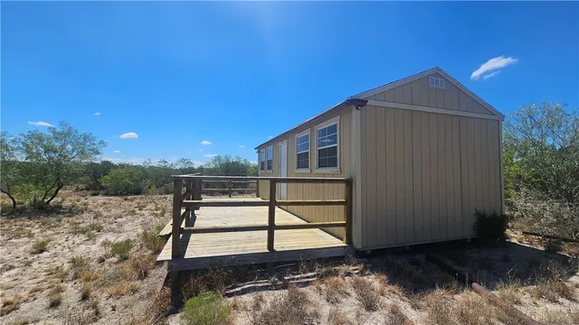 a view of a house with wooden floor and a backyard