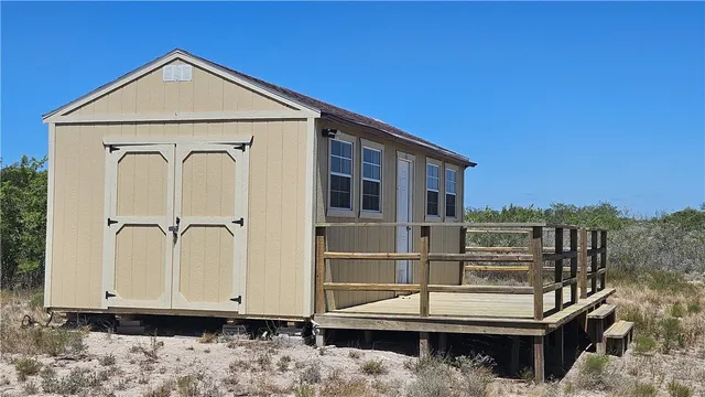 a view of backyard of house and car parked