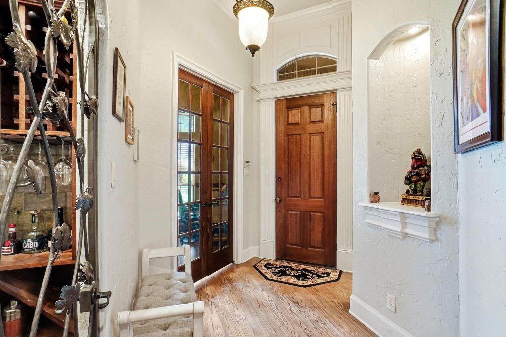 620 Highview Lane Hurst, TX 76054 - Photo 6 of 40 a bedroom with a bed and a chandelier