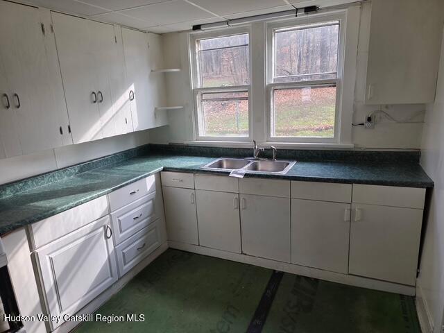 30 Highland Avenue Kerhonkson, NY 12446 - Photo 2 of 14 a kitchen with granite countertop white cabinets and window