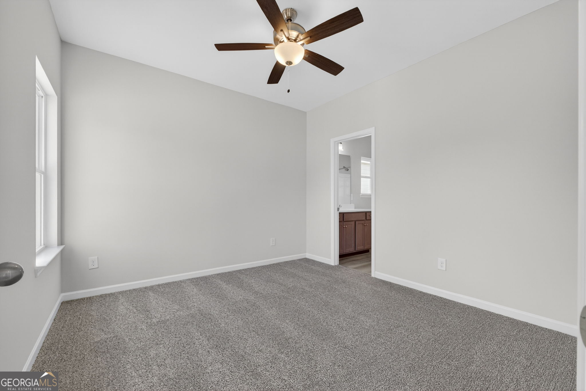 207 Riverview Road Franklin, GA 30217 - Photo 12 of 24 an empty room with closet and a ceiling fan