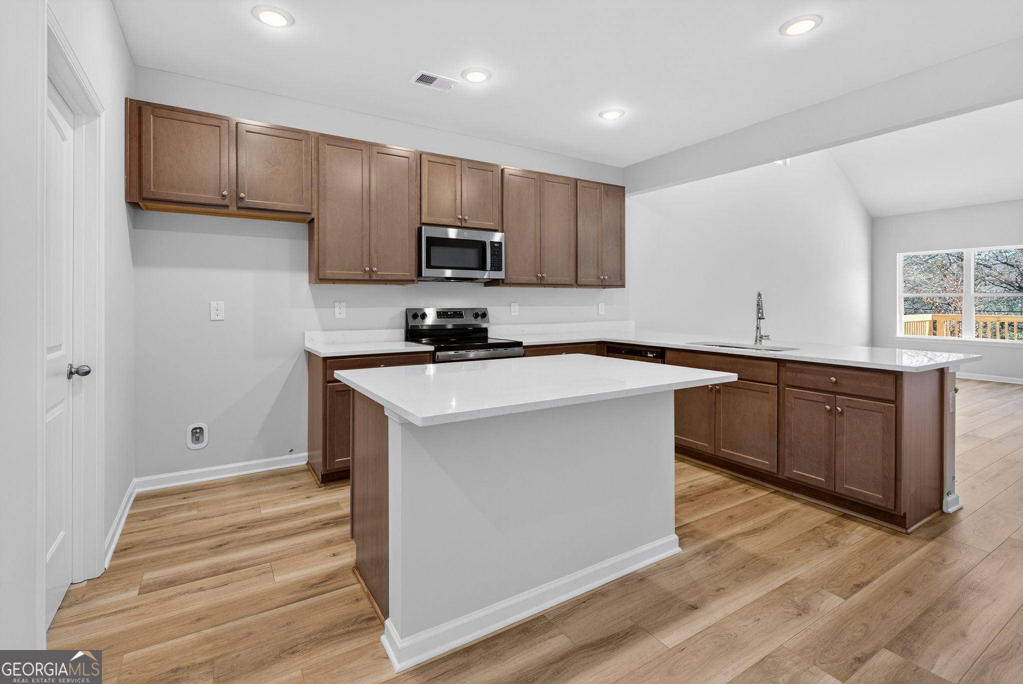207 Riverview Road Franklin, GA 30217 - Photo 5 of 24 a kitchen with stainless steel appliances a sink stove and cabinets