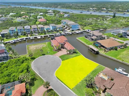 an aerial view of a resort with swimming pool outdoor seating