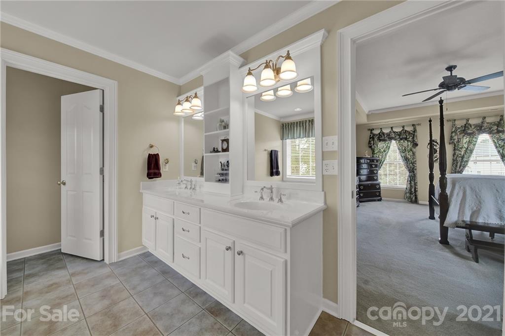 4509 Shadow Moss Circle Fort Mill, SC 29708 - Photo 16 of 43 a bathroom with a double vanity sink and a mirror