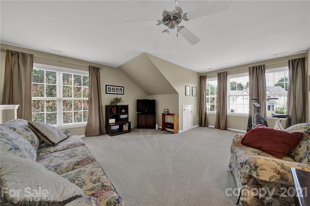 4509 Shadow Moss Circle Fort Mill, SC 29708 - Photo 28 of 43 a large bedroom with a large bed and a large window