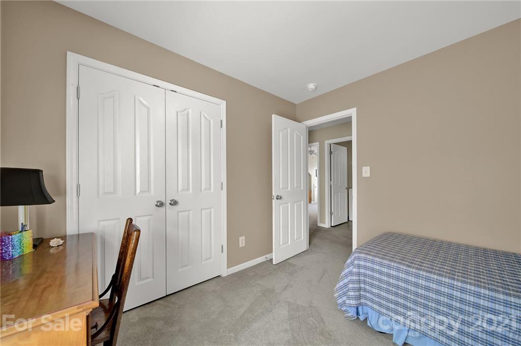 4509 Shadow Moss Circle Fort Mill, SC 29708 - Photo 32 of 43 a bedroom with a bed and a chair
