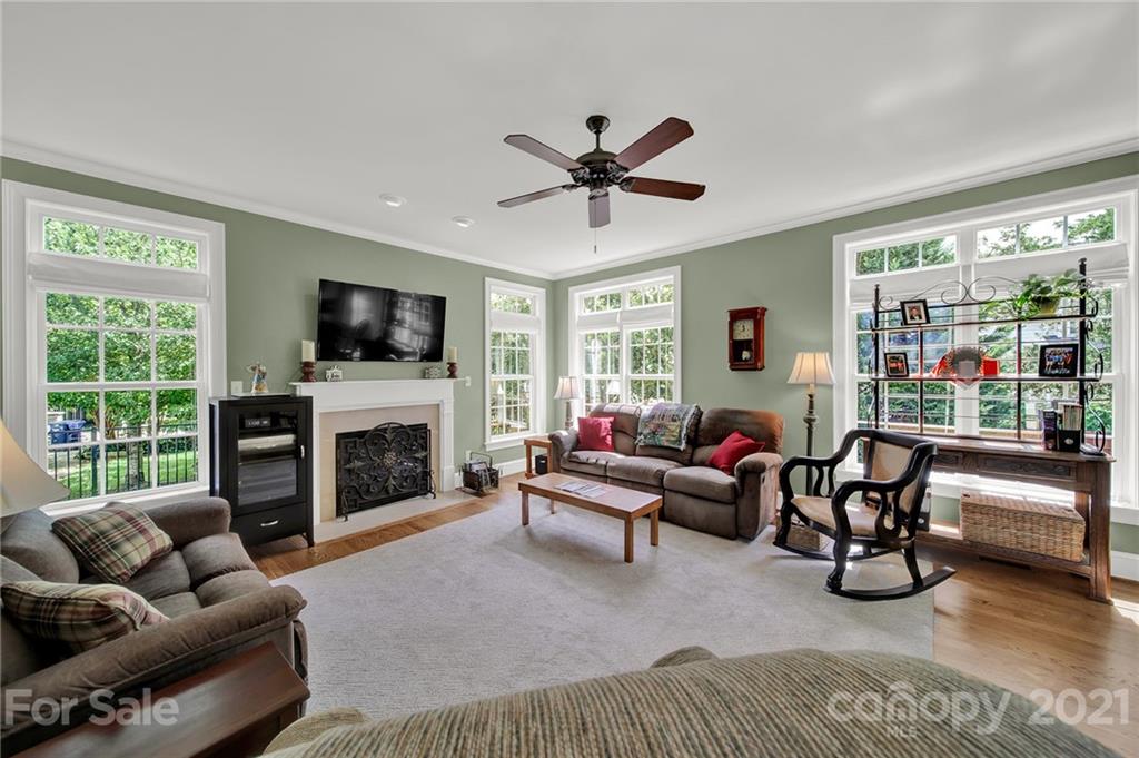 4509 Shadow Moss Circle Fort Mill, SC 29708 - Photo 5 of 43 a living room with furniture a fireplace and a flat screen tv