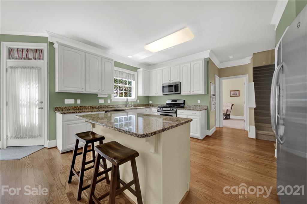 4509 Shadow Moss Circle Fort Mill, SC 29708 - Photo 9 of 43 a kitchen with a refrigerator and white cabinets