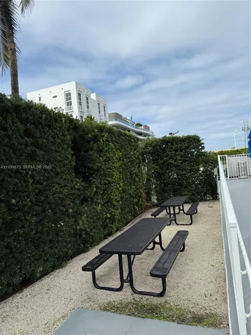a view of a patio with a table and chairs under an umbrella