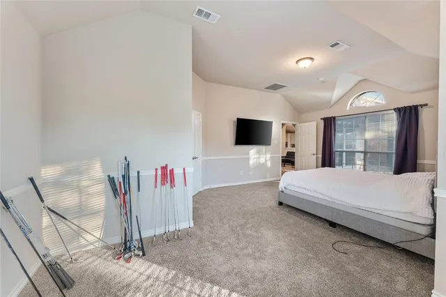 a bed room with a bed and a television