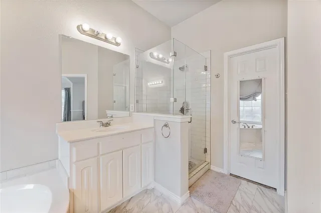 a bathroom with a double vanity sink mirror and shower