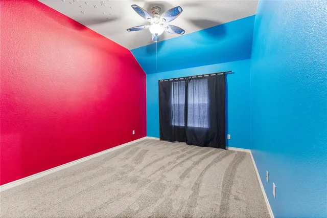 a view of a big room with closet and a ceiling fan