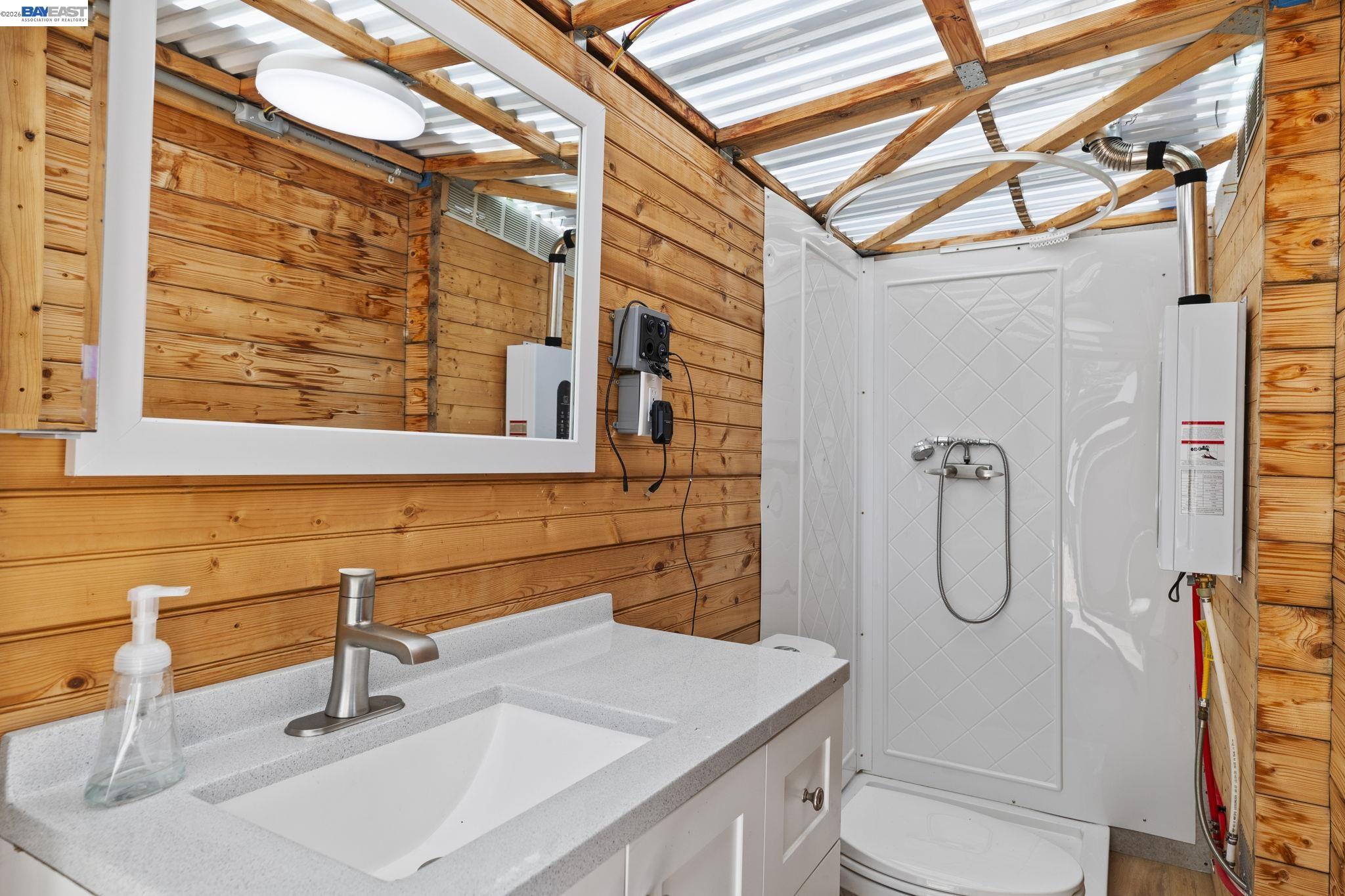 18188 West Corral Hollow Road Tracy, CA 95377 - Photo 15 of 58 a bathroom with a sink a toilet and shower