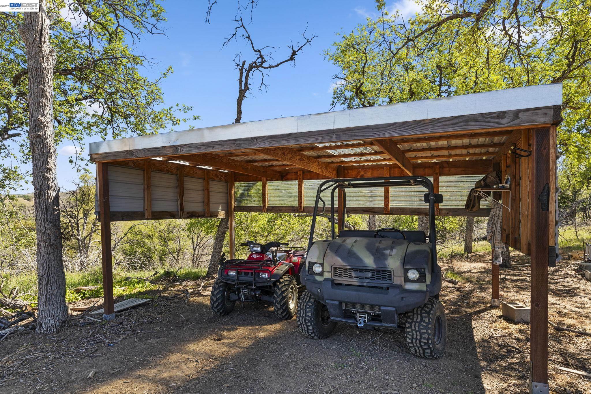 18188 West Corral Hollow Road Tracy, CA 95377 - Photo 22 of 58 a view of a patio with table and chairs under an umbrella with a small yard