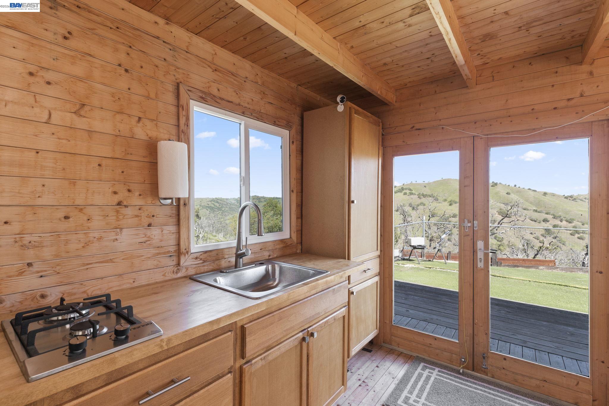 18188 West Corral Hollow Road Tracy, CA 95377 - Photo 8 of 58 a kitchen with sink a large window and stainless steel appliances