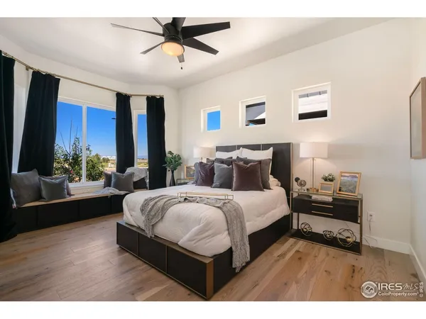 a bedroom with a large bed and a chandelier