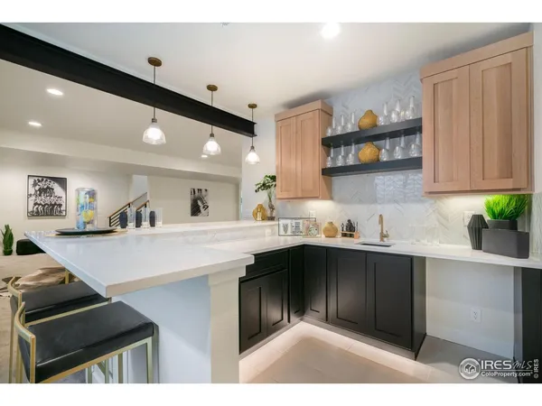 a kitchen with a sink dishwasher and a stove with wooden floor