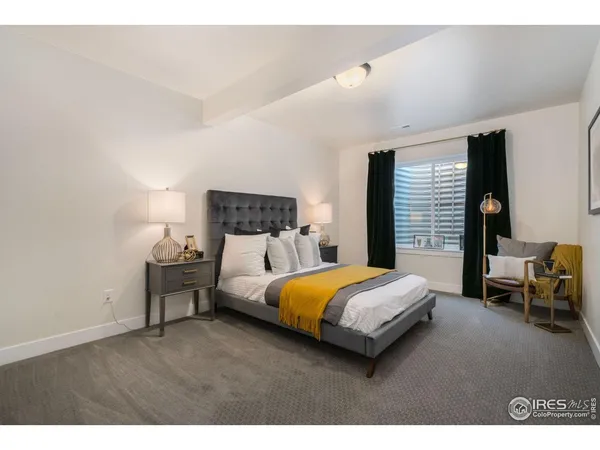 a bedroom with a bed and lamp