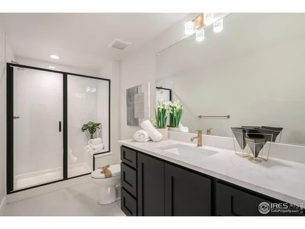 a bathroom with a sink a mirror and a shower