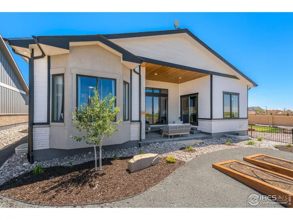 a view of a house with backyard porch and sitting area