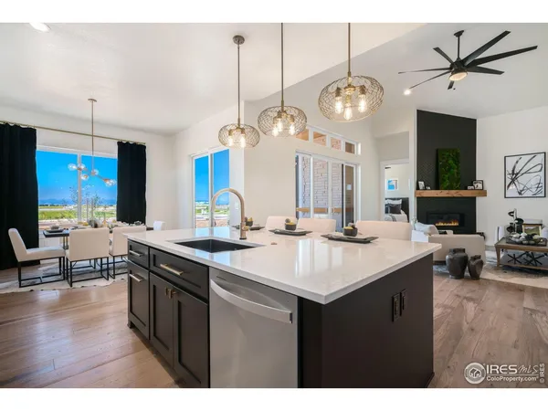 a kitchen with a sink a counter space and living room view