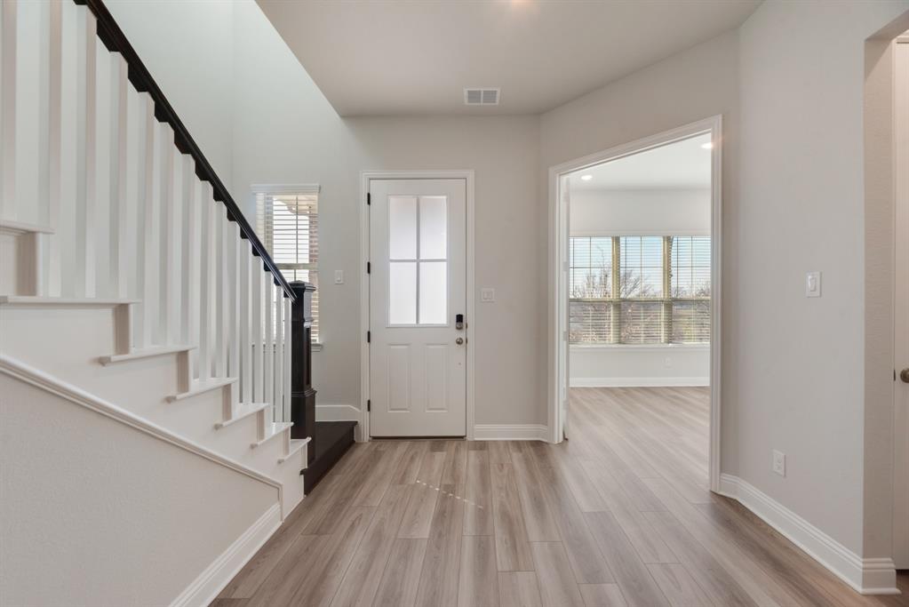 7009 Sunset Boulevard Rowlett, TX 75088 - Photo 4 of 35 a view of an entryway with wooden floor and door