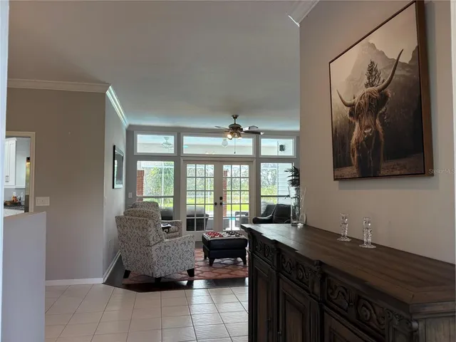 a living room with furniture and a floor to ceiling window