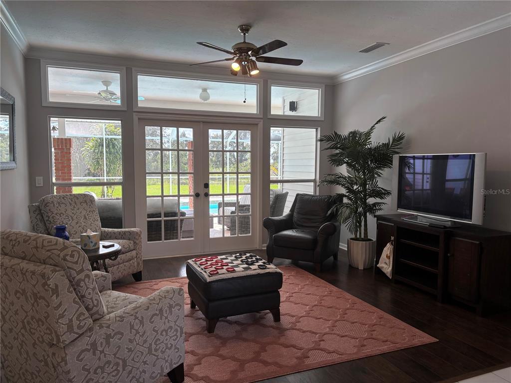 1950 Bern Creek Loop Sarasota, FL 34240 - Photo 16 of 60 a living room with furniture and a floor to ceiling window