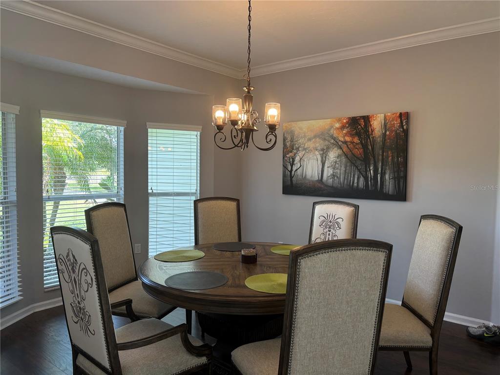 1950 Bern Creek Loop Sarasota, FL 34240 - Photo 18 of 60 a view of a dining room with furniture and chandelier