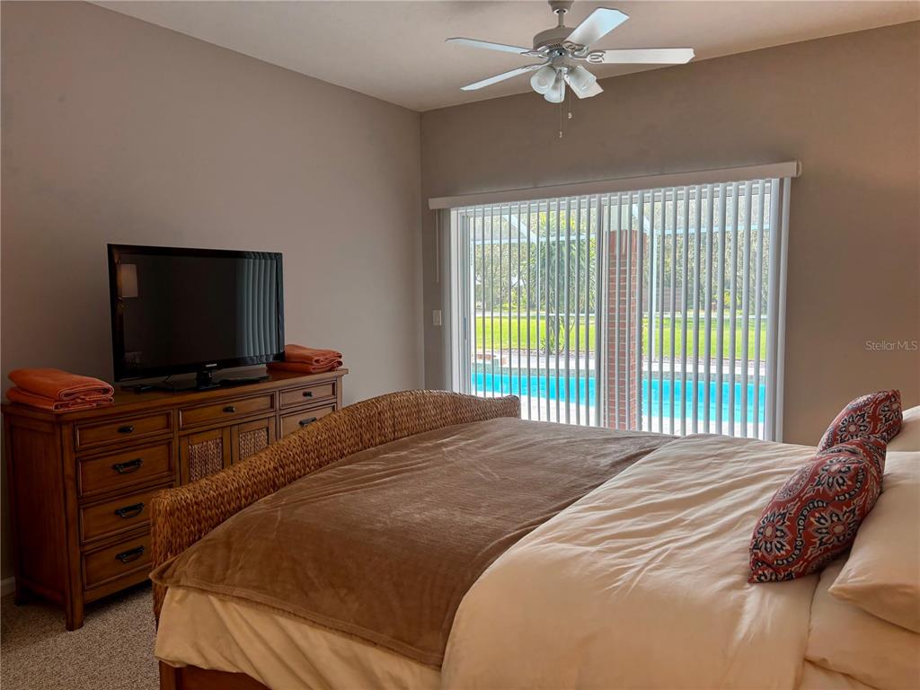 1950 Bern Creek Loop Sarasota, FL 34240 - Photo 25 of 60 a bedroom with a bed and a flat screen tv