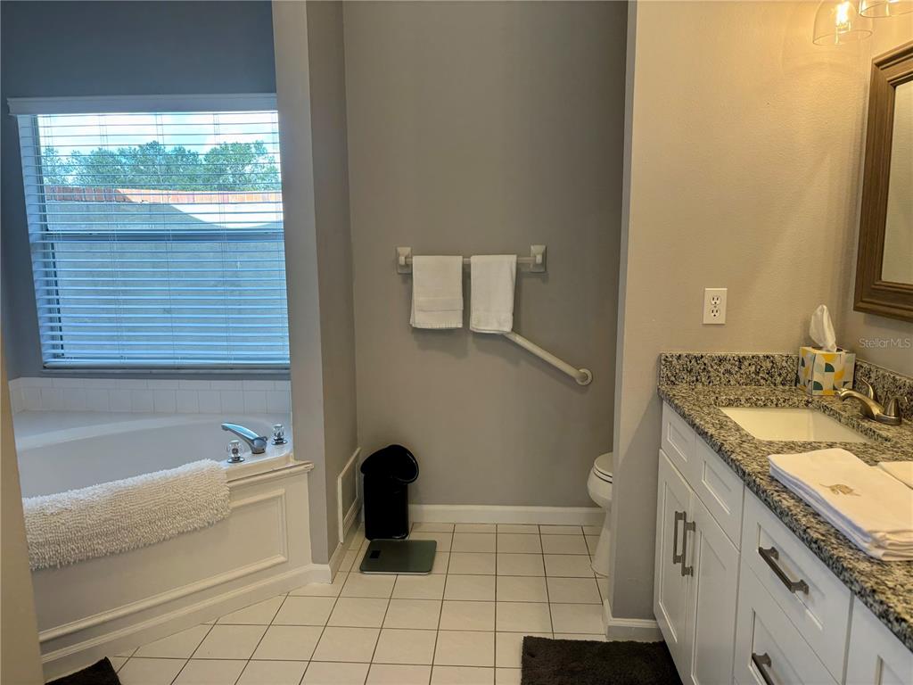 1950 Bern Creek Loop Sarasota, FL 34240 - Photo 28 of 60 a spacious bathroom with a granite countertop sink a toilet and bathtub