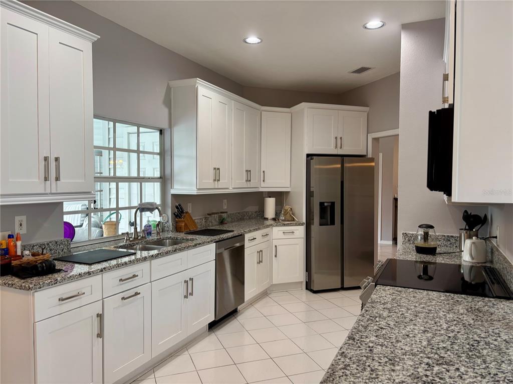 1950 Bern Creek Loop Sarasota, FL 34240 - Photo 31 of 60 a kitchen with a sink a refrigerator and window