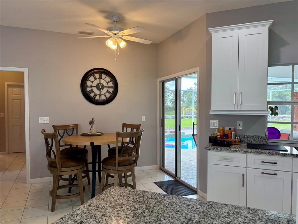 1950 Bern Creek Loop Sarasota, FL 34240 - Photo 32 of 60 a view of a kitchen with a dining table and chairs