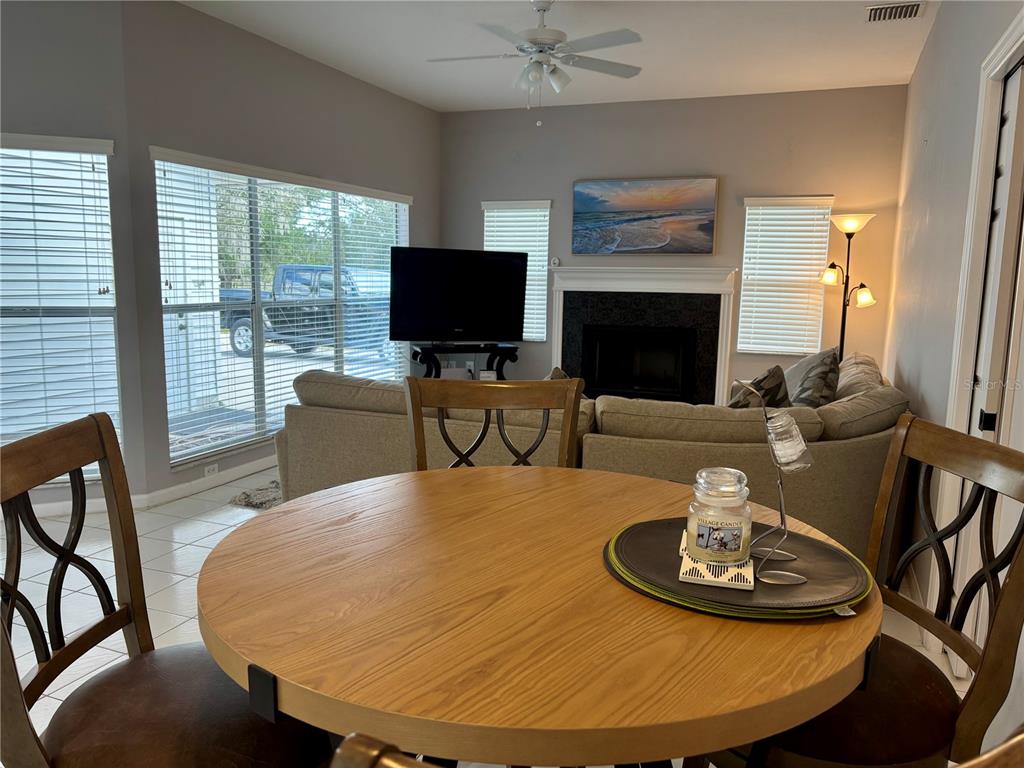 1950 Bern Creek Loop Sarasota, FL 34240 - Photo 37 of 60 a living room with furniture a fireplace and a flat screen tv
