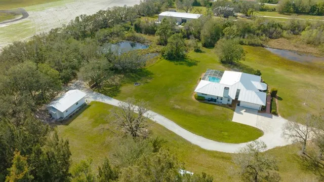 an aerial view of a house with a swimming pool