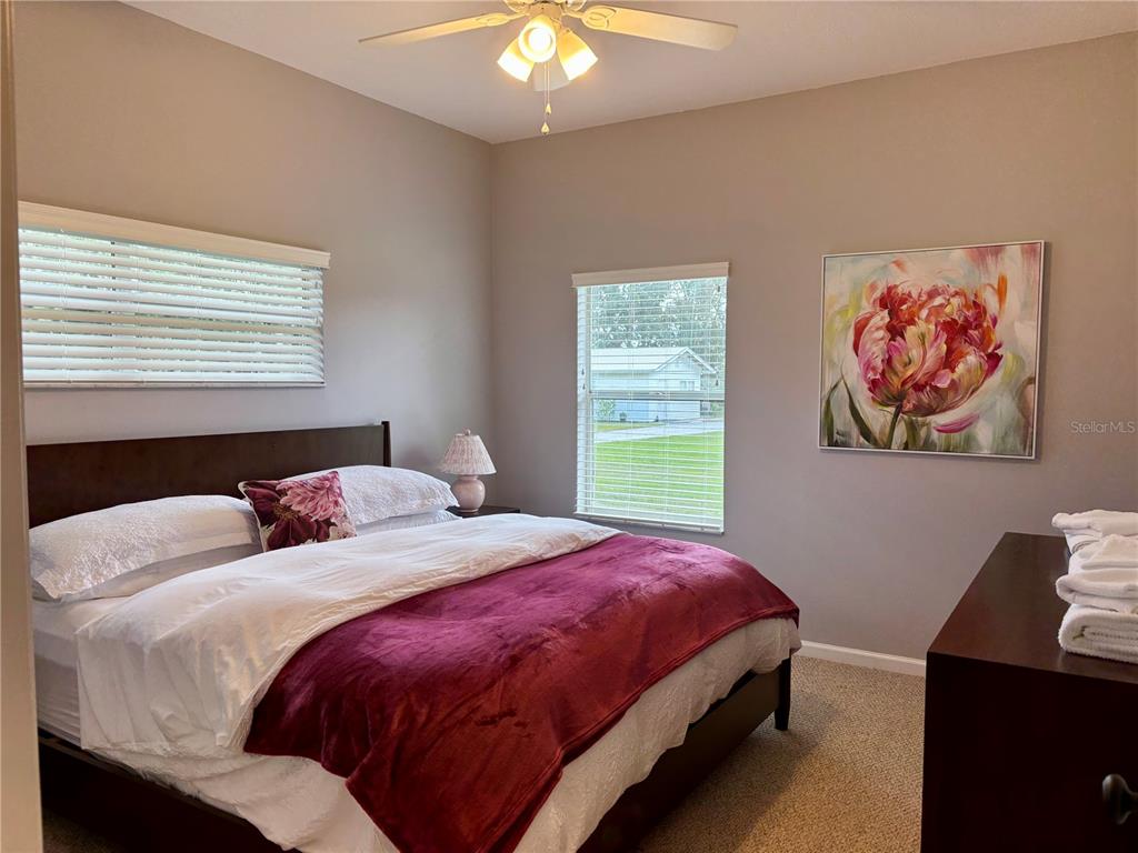 1950 Bern Creek Loop Sarasota, FL 34240 - Photo 42 of 60 a bedroom with a bed and a chandelier