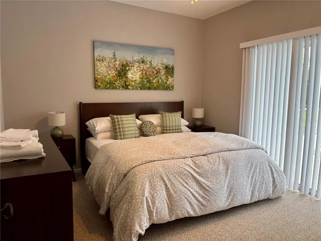 a view of a fountain in front of a house with a big yard