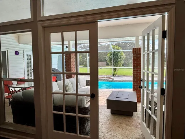 a view of a lake with a yard and large trees