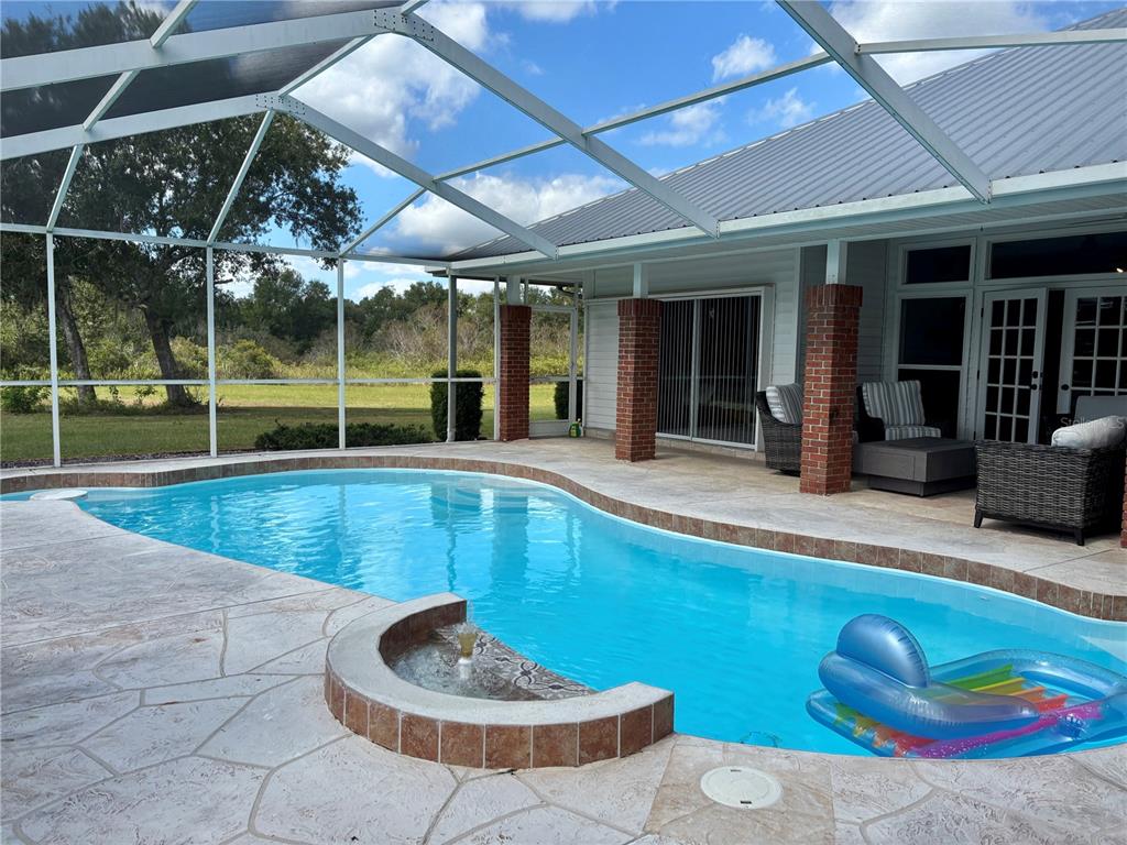1950 Bern Creek Loop Sarasota, FL 34240 - Photo 48 of 60 a view of a backyard with swimming pool and furniture